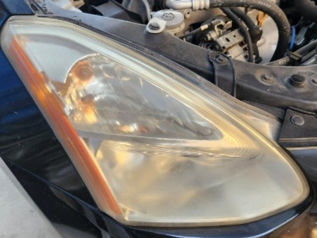 Before headlight restoration during Orange County auto detailing